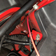 Hole in firewall with sound deadening and cable visible